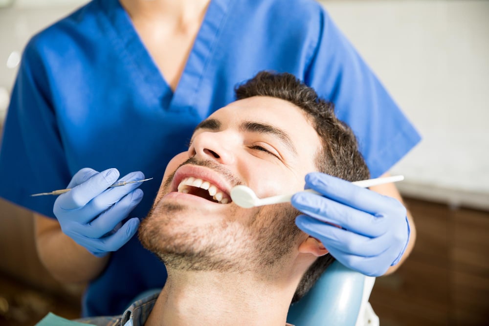 Dentist applying composite bonding on a front tooth.