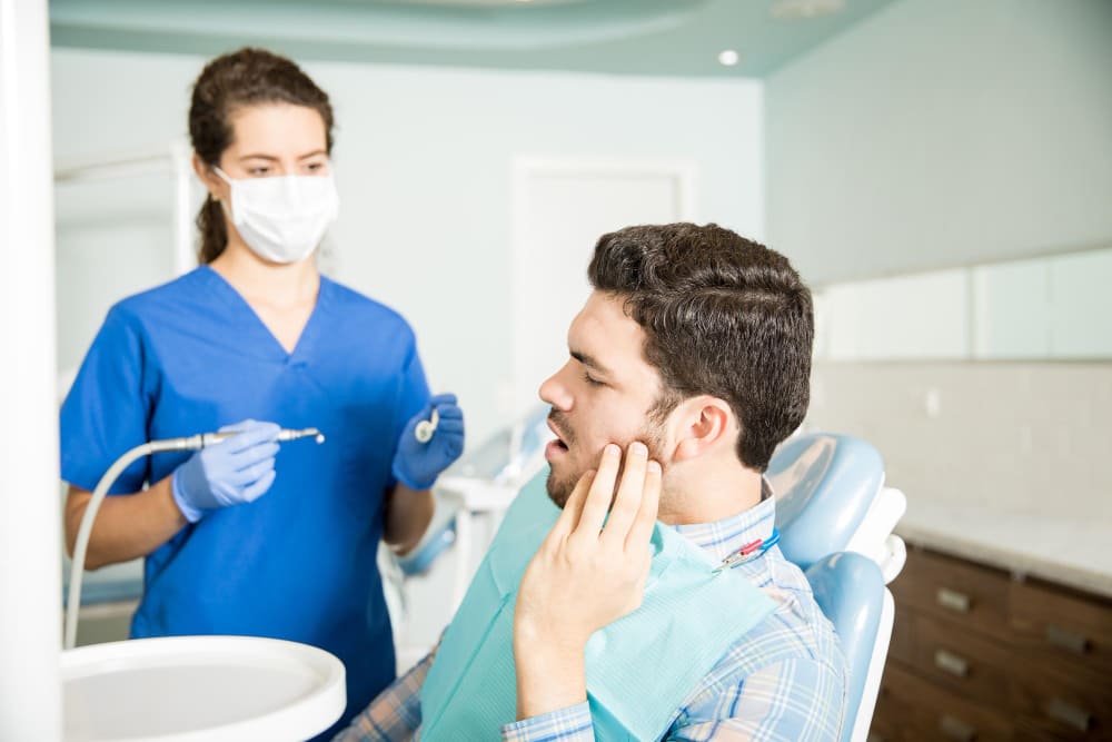 Dentist Consulting with Patient about TMJ Disorder Treatment Options