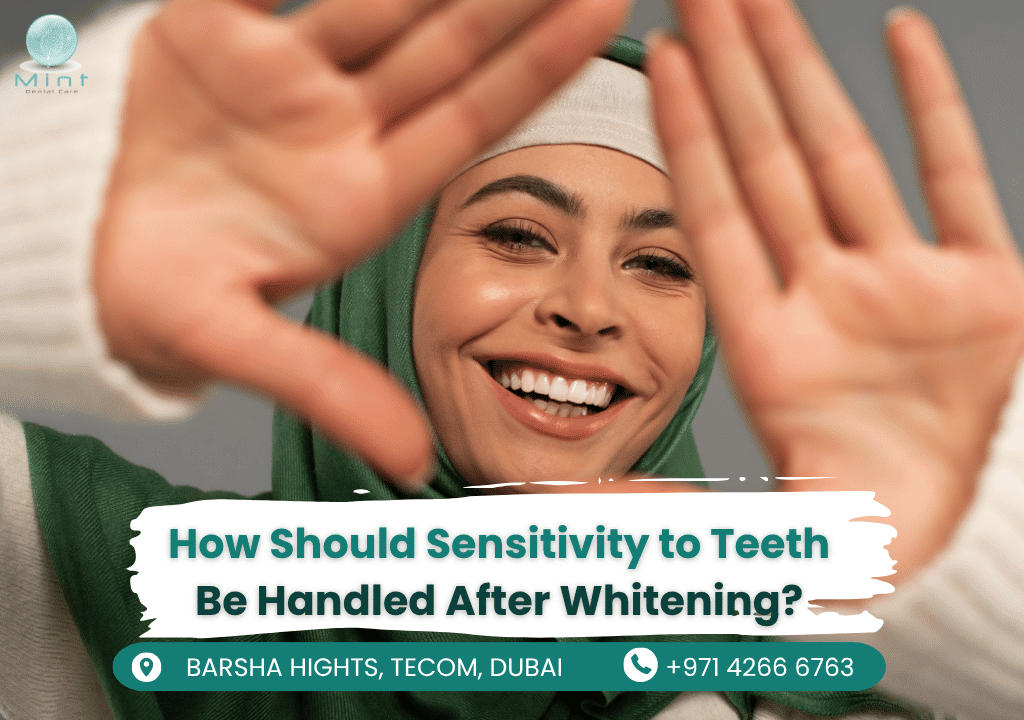 Woman smiling while holding sensitive teeth gel, showing post-whitening dental care at Mint Dental Care.