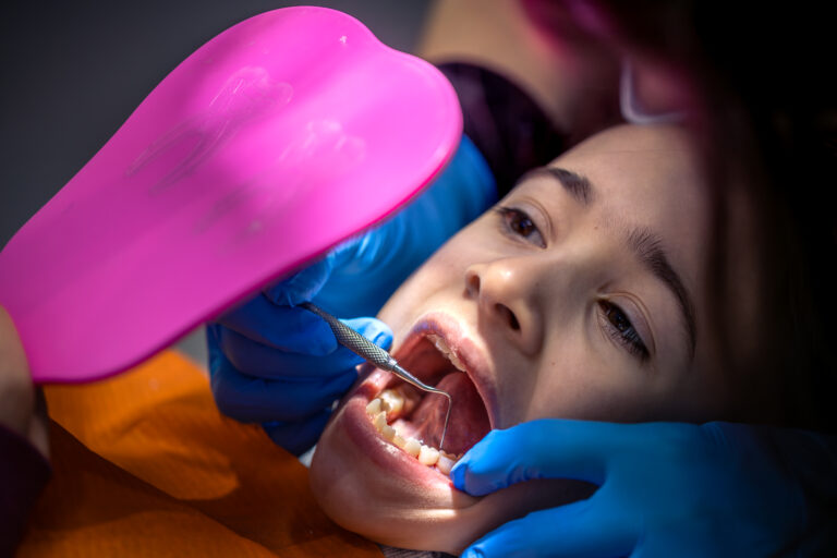 Child receiving Invisalign First clear aligners at Mint Dental Care